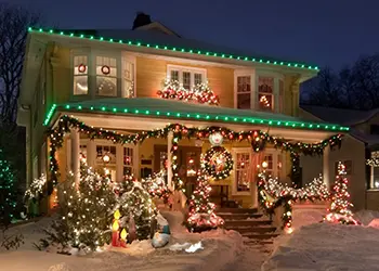 two-story house with green and white lights